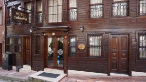 a building with wooden doors and windows on a street at Hotel SultanHill in Istanbul