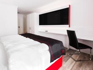 Ein Bett oder Betten in einem Zimmer der Unterkunft DORMERO Hotel München-Kirchheim Messe