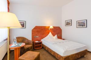 Postel nebo postele na pokoji v ubytování Hotel Quellenhof