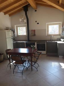 a kitchen with a table and chairs and a kitchen with a sink at La Casa di Franco in Rivoli Veronese +37 photos