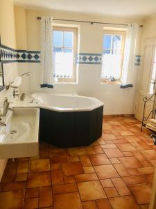 a large bathroom with a tub and a sink at "Bootsschuppen" by Ferienhaus Strandgut in Born
