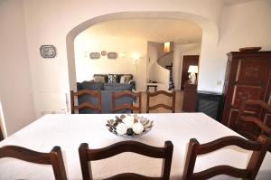 a dining room with a table and a living room at E&M Beach House Aldeamento do Levante III in Porches +13 photos