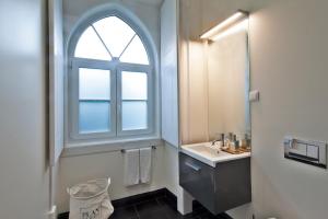 a bathroom with a toilet, sink and window at Lisbon Canaan Boutique Apartments Gaivotas in Lisbon