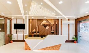 a lobby with a reception desk and a tv at Treebo Trend Resto- Hotel near Lucknow Railway Station in Lucknow