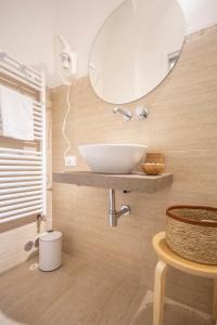 a bathroom with a white sink and a mirror at La Lu cozy rooms in Pisa