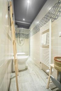 a bathroom with a toilet and a shower in it at La Lu cozy rooms in Pisa +44 photos