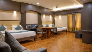 Postel nebo postele na pokoji v ubytování Hotel ARJUNAA