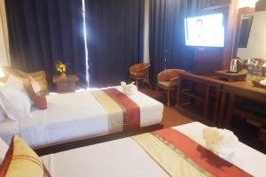 Postel nebo postele na pokoji v ubytování Sengahloune Resort