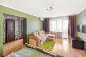 a living room with a couch and a table at Apartments Abazhur on Kareltseva 101 in Kurgan