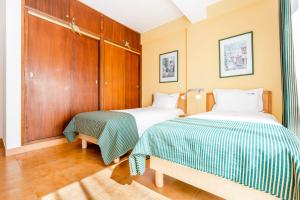 dwa łóżka siedzące obok siebie w pokoju w obiekcie Altura Inn Beach w mieście Altura