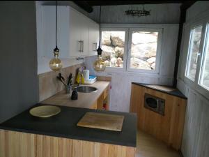 a kitchen with a counter and a sink and a window at El Jardín de las Hadas in Turre