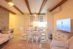 a kitchen and dining room with a table and chairs at Villa Retro fusion a luxury villa in Tucepi in Tučepi