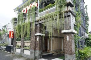 a building with ivy on the side of it at Super OYO 444 Rafitha Homestay in Yogyakarta