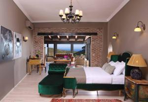 a bedroom with a bed and a living room at Manici Kasri in Kucukkuyu