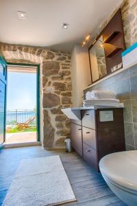 a stone bathroom with a sink and a toilet at Villa Andrea in Brela, private pool in Brela