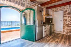 a kitchen with a door leading to a patio at Villa Andrea in Brela, private pool in Brela