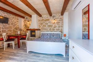 a bedroom with a bed and a table in a room at Villa Andrea in Brela, private pool in Brela