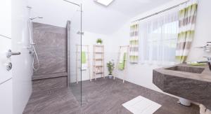 a bathroom with a shower and a sink at Oberschartlhof in Flachau +20 photos