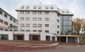 a large white building with a lot of windows at Luch Hotel in Moscow