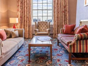 a living room with two couches and a table at The White Lion Hotel in Aldeburgh