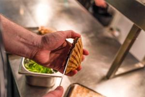 a person holding up a piece of food at The White Lion Hotel in Aldeburgh