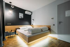 a hotel room with a bed, desk and a lamp at Yard Hostel & Coffee in Chernivtsi