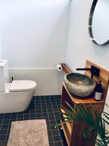 a bathroom with a sink and a toilet at Pacific Terraces 2, 38 Pacific Street in Crescent Head