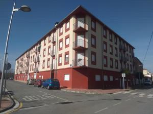a large building on the side of a street at Apartamento Rio Lavilla in Castañares de Rioja