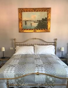 a bedroom with a bed with a picture on the wall at B&B Borghi in Como