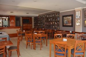 a dining room with wooden tables and chairs at Mercedes Park Hotel in Villa Mercedes