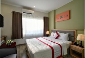 Un pat sau paturi într-o cameră la Hue My Hotel