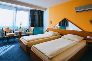 Postel nebo postele na pokoji v ubytování Hotel Central