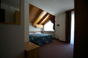 Un ou plusieurs lits dans un hébergement de l'établissement Hotel Sciatori