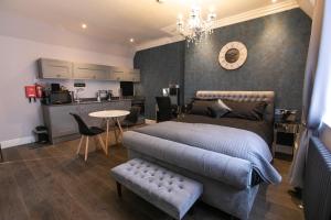 a bedroom with a large bed and a kitchen at Number 82 The Unthank in Norwich