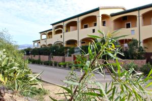 a building on the side of a road at Casa THE NEST - Il Nido sul Mare in Badesi