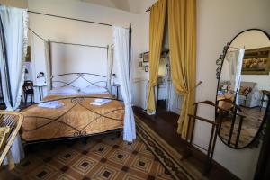 a bedroom with a large bed and a mirror at Palazzo Barba in Gallipoli