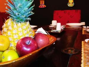 a bowl of apples and a pineapple on a table at Casa India Catalina in Cartagena de Indias