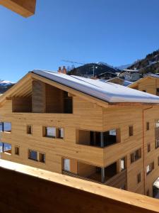 a building with a roof on top of it at Catrina Resort in Disentis