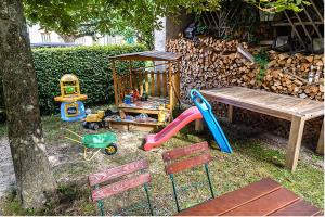 a playground with a bench and a play table at Landgasthof Zur Sonne in Fünfstetten