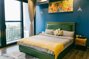 a bedroom with a bed with a blue wall at Saipan Skyline Designers Hotel in Saipan +37 photos
