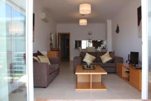 a living room with two couches and a coffee table at Apartamento Ria Formosa no Mar in Fuzeta