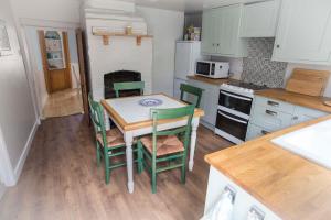 a kitchen with a table and chairs in it at Spencer House in Sandwich