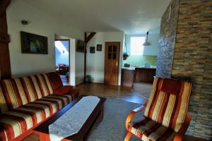 a living room with a couch and two chairs at Pojezierze Drawskie Agroturystyka Greanna in Ostrowice