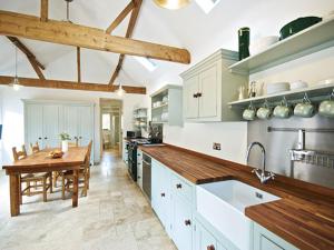 a large kitchen with a table and a dining room at The Hamlet in Cromer
