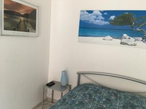 a bedroom with a bed and a picture on the wall at Chambre du verger in Francheville