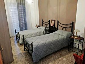 מיטה או מיטות בחדר ב-A Casa di Raffy
