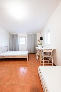 a room with two beds and a table in it at Slavia penzion in Mikulov