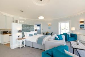a bedroom with a bed and a living room at Sandhills Apartments, Mudeford in Christchurch