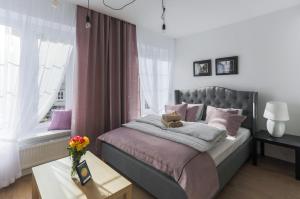 Posteľ alebo postele v izbe v ubytovaní Central Apartments Piwna