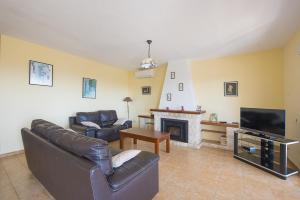 a living room with a couch and a fireplace at Villa Roel in Calpe